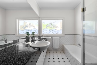Mission Bay guest bathroom featuring clever storage solutions and beach-inspired tile work